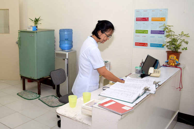 Image of a person with a book inside the clinic